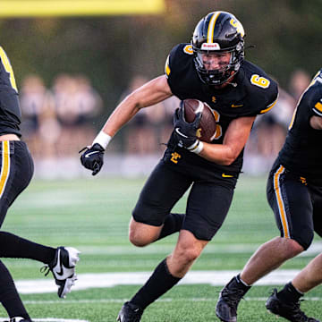 Southeast Polk's Sam Zelenovich (6) carries the ball for a gain of yards against Valley on Friday, Aug. 30, 2024, at Southeast Polk Stadium.