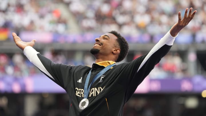 Aug 4, 2024; Paris, FRANCE; Silver medalist Leo Neugebauer (GER) celebrates during the medal ceremony for the decathlon during the Paris 2024 Olympic Summer Games at Stade de France. Mandatory Credit: Kirby Lee-USA TODAY Sports