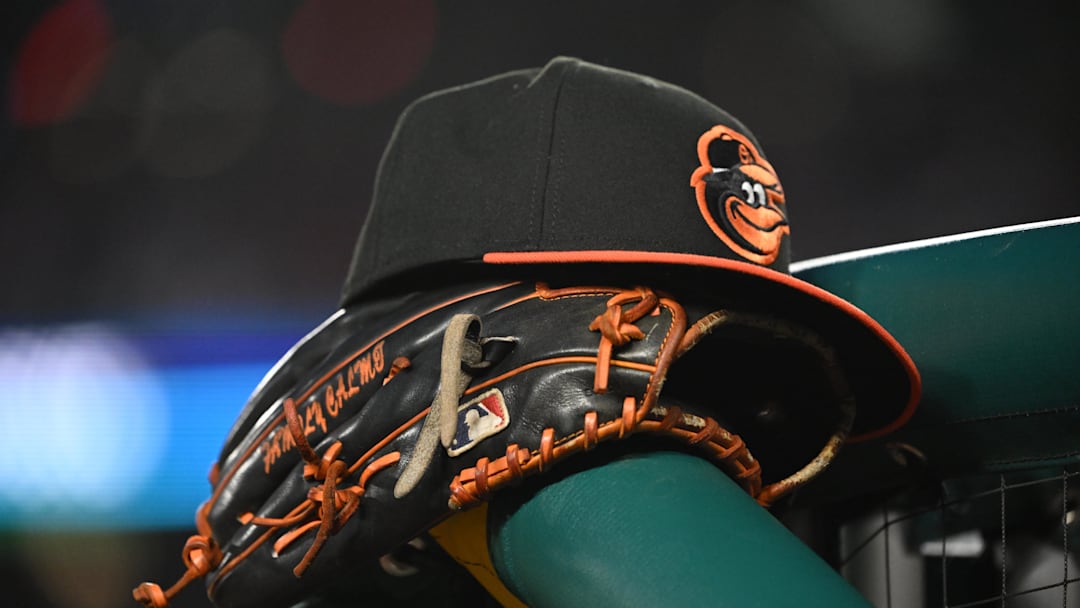 May 8, 2024; Washington, District of Columbia, USA; A Baltimore Orioles hat and glove rest on the dugout rail during a game against the Washington Nationals at Nationals Park. May 8, 2024; Washington, District of Columbia, USA; A Baltimore Orioles hat and glove rest on the dugout rail during a game against the Washington Nationals at Nationals Park.