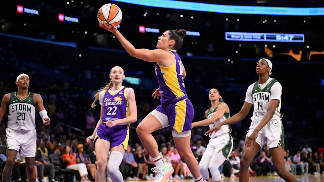 Aug 10, 2025; Los Angeles, California, USA; Los Angeles Sparks guard Kelsey Plum (10) drives to the basket past Seattle Storm center Dominique Malonga (14) during the second quarter at Crypto.com Arena. Mandatory Credit: Robert Hanashiro-Imagn Images