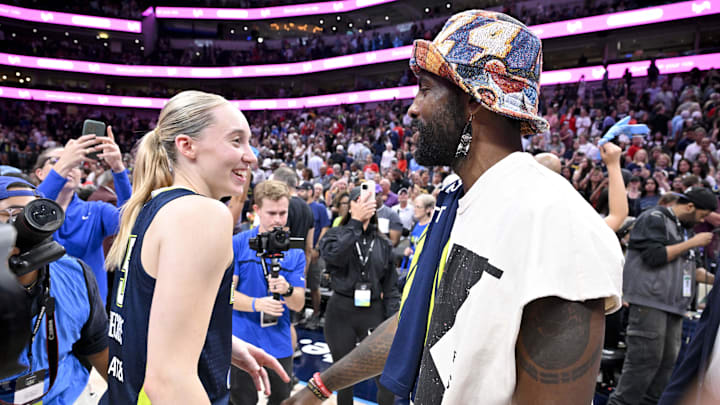 Jun 27, 2025; Dallas, Texas, USA; Dallas Mavericks point guard Kyrie Irving talks with Dallas Wings guard Paige Bueckers (5) after the game against the Indiana Fever at the American Airlines Center. Mandatory Credit: Jerome Miron-Imagn Images