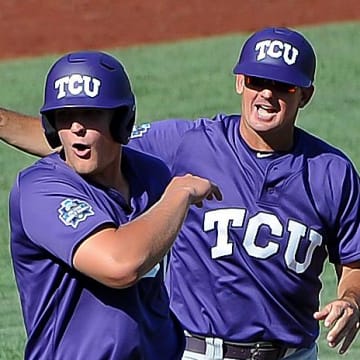 Jun 19, 2016; Omaha, NE, USA; TCU Horned Frogs infielder Luken Baker (19) celebrates with assistant coach Bill Mosiello after a ninth inning home run against the Texas Tech Red Raiders in the 2016 College World Series at TD Ameritrade Park. TCU won 5-3. Mandatory Credit: Steven Branscombe-USA TODAY Sports