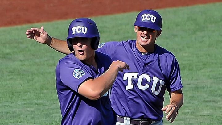 Jun 19, 2016; Omaha, NE, USA; TCU Horned Frogs infielder Luken Baker (19) celebrates with assistant coach Bill Mosiello after a ninth inning home run against the Texas Tech Red Raiders in the 2016 College World Series at TD Ameritrade Park. TCU won 5-3. Mandatory Credit: Steven Branscombe-USA TODAY Sports