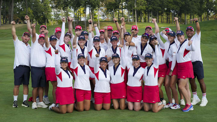 Members of Team USA and their caddies after defeating Team Europe in the 2024 Solheim Cup.