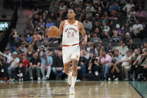 San Antonio Spurs guard Devin Vassell (24) dribbles in the first half against the Phoenix Suns at Frost Bank Center. 