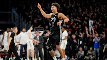 Cincinnati Bearcats guard Dan Skillings Jr. (0) celebrates as time expires in the second half of the 92nd Annual Crosstown Shootout NCAA basketball game between the Cincinnati Bearcats and the Xavier Musketeers at Fifth Third Arena on the UC campus in Cincinnati on Saturday, Dec. 14, 2024. The Bearcats won 68-65.