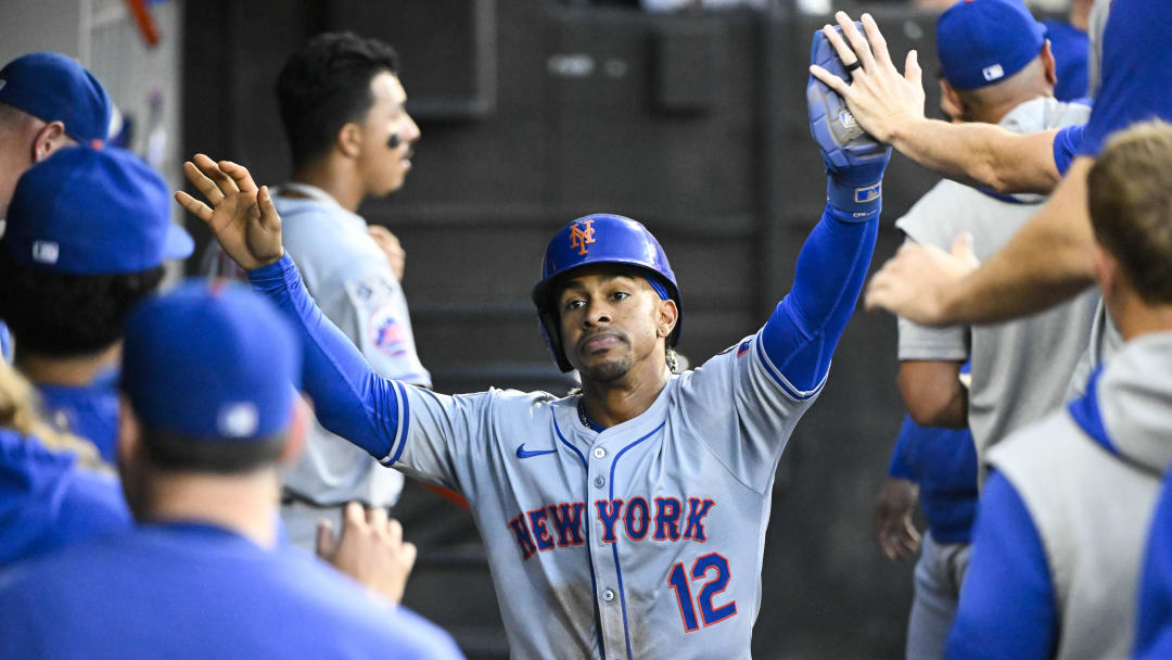 Aug 31, 2024; Chicago, Illinois, USA;  New York Mets shortstop Francisco Lindor (12) celebrates in the dugout after he scores against the Chicago White Sox during the third inning at Guaranteed Rate Field. Mandatory Credit: Matt Marton-USA TODAY Sports