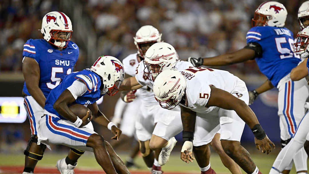 Sep 28, 2024; Dallas, Texas, USA; Florida State Seminoles defensive lineman Joshua Farmer (5) and linebacker Blake Nichelson (20) attempts to tackle Southern Methodist Mustangs quarterback Kevin Jennings (7) during the first quarter at Gerald J. Ford Stadium. Mandatory Credit: Jerome Miron-Imagn Images
