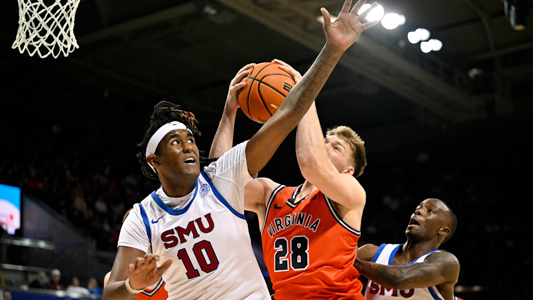 Jan 17, 2026; Dallas, Texas, USA; SMU Mustangs center Jaden Toombs (10) and Virginia Cavaliers forward Thijs de Ridder (28) battle for the rebound during the first half at Moody Coliseum. Mandatory Credit: Jerome Miron-Imagn Images