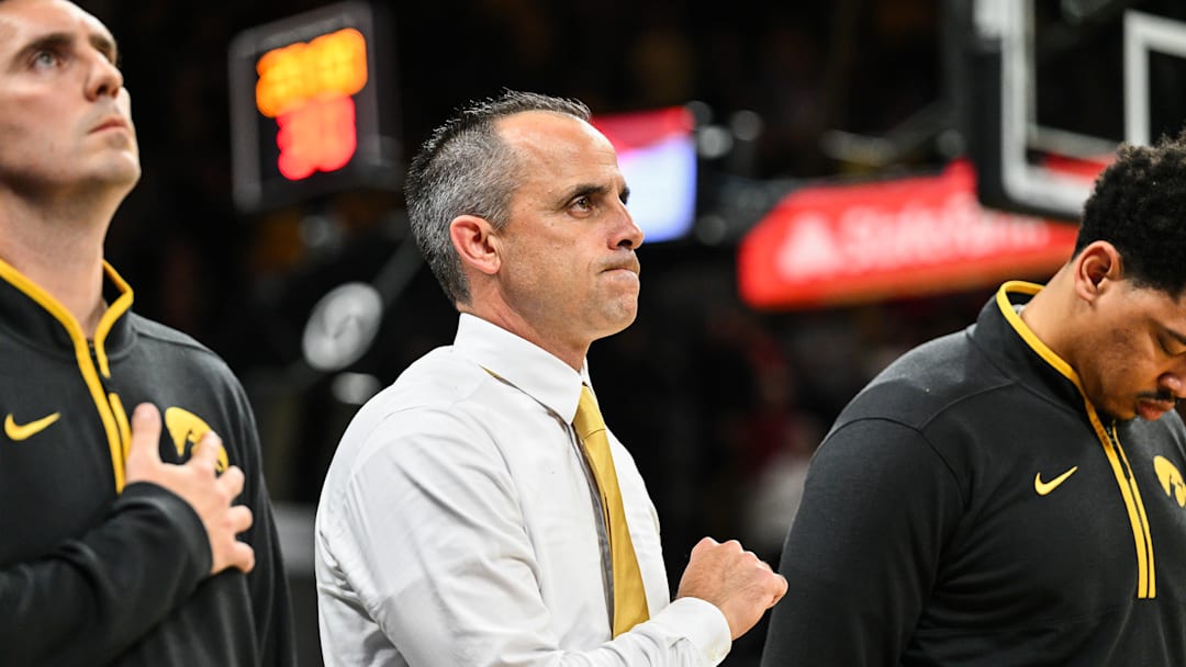 Nov 4, 2025; Iowa City, Iowa, USA; Iowa Hawkeyes head coach Ben McCollum stands for the national anthem at Carver-Hawkeye Arena for his first game as the Hawkeyes head coach before the game against the Robert Morris Colonials. Mandatory Credit: Jeffrey Becker-Imagn Images