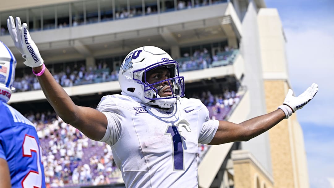 Sep 20, 2025; Fort Worth, Texas, USA; TCU Horned Frogs wide receiver Eric McAlister (1) celebrates in front of SMU Mustangs safety Abdul Muhammad (27) after McAlister scores a touchdown during the second half at Amon G. Carter Stadium. Mandatory Credit: Jerome Miron-Imagn Images