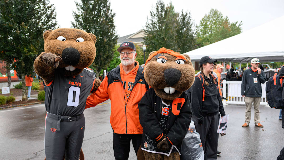 Oct 11, 2025; Corvallis, Oregon, USA; Oregon State Beavers fan poses with the mascots Benny and Bernice outside Reser Stadium before the game against the Wake Forest Demon Deacons. Mandatory Credit: Craig Strobeck-Imagn Images