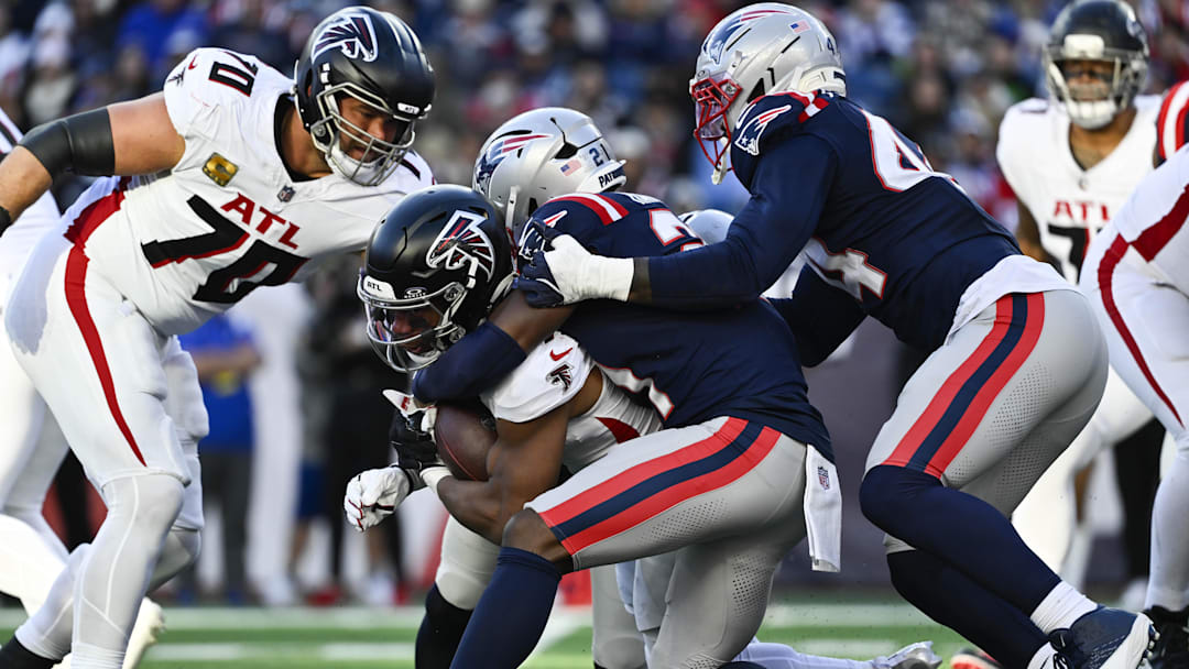 Nov 2, 2025; Foxborough, Massachusetts, USA;  Atlanta Falcons running back Bijan Robinson (7) is tackled by New England Patriots safety Jaylinn Hawkins (21) during the third quarter at Gillette Stadium. Mandatory Credit: Eric Canha-Imagn Images