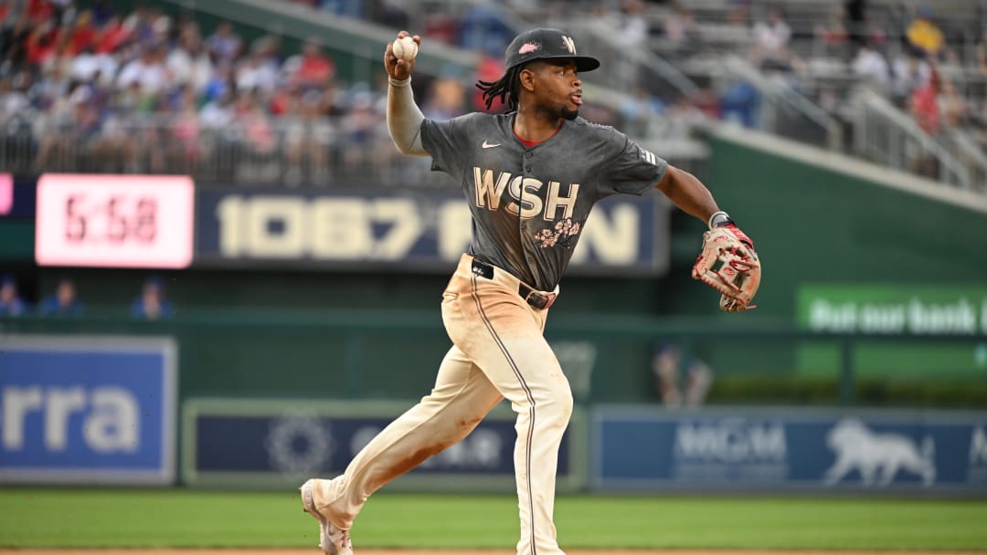 Aug 31, 2024; Washington, District of Columbia, USA; Washington Nationals third baseman Jose Tena (8) attempts a throw to first base against the Chicago Cubs during the seventh inning at Nationals Park.