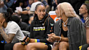 Jun 28, 2025; Arlington, Texas, USA; Dallas Wings guard Haley Jones (left) talks with guard DiJonai Carrington (right) on the bench during the second half against the Washington Mystics at College Park Center. Mandatory Credit: Jerome Miron-Imagn Images