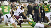 Nov 14, 2025; Eugene, Oregon, USA; Minnesota Golden Gophers running back Darius Taylor (1) breaks away from Oregon Ducks linebacker Teitum Tuioti (44) during the first half at Autzen Stadium. Mandatory Credit: Troy Wayrynen-Imagn Images