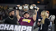 Dec 7, 2024; Arlington, TX, USA; Arizona State Sun Devils running back Cam Skattebo (4) holds up the WWE Big 12 championship belt after the Sun Devils defeat the Iowa State Cyclones and win the 2024 Big 12 Championship at AT&T Stadium. Mandatory Credit: Jerome Miron-Imagn Images