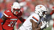 Oct 4, 2025; Louisville, Kentucky, USA; Virginia Cavaliers wide receiver Cam Ross (6) catches a pass against Louisville Cardinals defensive back D'Angelo Hutchinson (21) during the second quarter at L&N Federal Credit Union Stadium. Mandatory Credit: Jamie Rhodes-Imagn Images