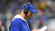 Nov 23, 2025; Detroit, Michigan, USA; New York Giants interim head coach Mike Kafka reviews the play sheet during the third quarter against the Detroit Lions at  Ford Field.  