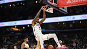 Nov 16, 2025; Washington, District of Columbia, USA;  Brooklyn Nets center Nic Claxton (33) hangs on the rim after a slam dunk against the Washington Wizards during the first quarter at Capital One Arena. Mandatory Credit: Rafael Suanes-Imagn Images