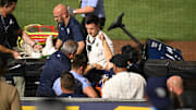 Tampa Bay Rays  pitcher Hunter Bigge (43) gets medical attention after getting hit in the face by a foul ball in the seventh inning against the Baltimore Orioles at George M. Steinbrenner Field. Jonathan Dyer-Imagn Images