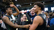 Jan 21, 2024; New Orleans, Louisiana, USA; Tulane Green Wave forward Gregg Glenn III (2), Tulane Green Wave forward Collin Holloway (5) and Tulane students celebrate their victory against the Memphis Tigers at Avron B. Fogelman Arena in Devlin Fieldhouse. Mandatory Credit: Matthew Hinton-Imagn Images
