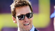 Tom Brady talks on the field before the Cleveland Browns' game against the Dallas Cowboys, his debut as a Fox Sports broadcaster. 