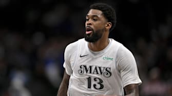 Dallas Mavericks forward Naji Marshall brings the ball up court against the Phoenix Suns.