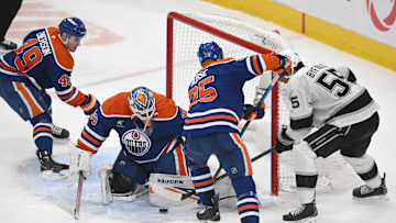 Edmonton Oilers goalie Calvin Pickard (30) looks for the puck with defenseman Darnell Nurse (25) against Los Angeles Kings right wing Quinton Byfield (5)