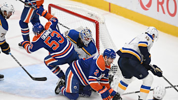 Apr 9, 2025; Edmonton, Alberta, CAN; Edmonton Oilers center Jeff Skinner (53) crashes into St. Louis Blues goalie Jordan Binnington (50) as Oilers defenseman Evan Bouchard (2) hits the ice during the third period at Rogers Place. Mandatory Credit: Walter Tychnowicz-Imagn Images
