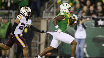 Nov 14, 2025; Eugene, Oregon, USA; Oregon Ducks running back Jordon Davison (0) breaks away from Minnesota Golden Gophers defensive back Jai'Onte' McMillan (24) during the first half for a touchdown at Autzen Stadium. Mandatory Credit: Troy Wayrynen-Imagn Images