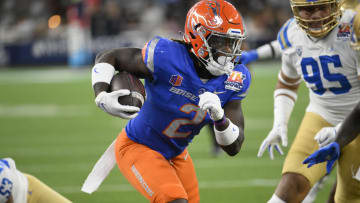 Dec 16, 2023; Inglewood, CA, USA; Boise State Broncos running back Ashton Jeanty (2) slips a tackle by UCLA Bruins linebacker Darius Muasau (53) during the first quarter of the Starco Brands LA Bowl at SoFi Stadium. Mandatory Credit: Robert Hanashiro-USA TODAY Sports