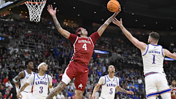 Mar 20, 2025; Providence, RI, USA;  Arkansas Razorbacks forward Trevon Brazile (4) reaches for the ball against Kansas Jayhawks center Hunter Dickinson (1) during the second half at Amica Mutual Pavilion. Mandatory Credit: Eric Canha-Imagn Images