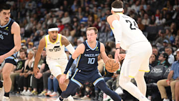 Mar 12, 2025; Memphis, Tennessee, USA; Memphis Grizzlies shooting guard Luke Kennard (10) dribbles past defenders during the game at FedExForum. Mandatory Credit: Matthew Smith-Imagn Images