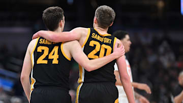 Mar 13, 2025; Indianapolis, IN, USA; Iowa Hawkeyes forward Pryce Sandfort (24) and Iowa Hawkeyes forward Payton Sandfort (20) during the second half against the Illinois Fighting Illini at Gainbridge Fieldhouse. Mandatory Credit: Robert Goddin-Imagn Images