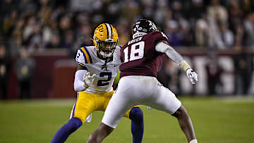 Nov 26, 2022; College Station, Texas, USA; LSU Tigers cornerback Mekhi Garner (2) and Texas A&M Aggies tight end Donovan Green (18) in action during the game between the Texas A&M Aggies and the LSU Tigers at Kyle Field. Mandatory Credit: Jerome Miron-Imagn Images