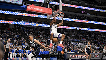 Mar 3, 2025; Dallas, Texas, USA; Sacramento Kings forward Trey Lyles (41) dunks the ball over Dallas Mavericks guard Dante Exum (0) during the second half at the American Airlines Center. Mandatory Credit: Jerome Miron-Imagn Images