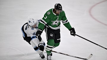 Apr 12, 2025; Dallas, Texas, USA; Dallas Stars defenseman Matt Dumba (3) keeps the puck away from Utah Hockey Club center Alexander Kerfoot (15) during the first period at the American Airlines Center. Mandatory Credit: Jerome Miron-Imagn Images