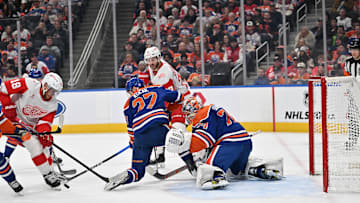 Dec 11, 2025; Edmonton, Alberta, CAN; Detroit Red Wings center Andrew Copp (18) tries to get the puck past Edmonton Oilers defenseman Brett Kulak (27) as he gets in front of Edmonton Oilers goalie Stuart Skinner (74) during the second period at Rogers Place. Mandatory Credit: Walter Tychnowicz-Imagn Images