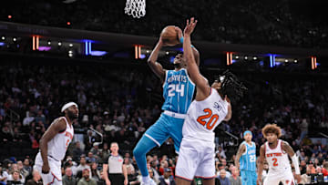 Oct 15, 2024; New York, New York, USA; Charlotte Hornets forward Brandon Miller (24) shoots the ball while being defended by New York Knicks center Jericho Sims (20) during the second half at Madison Square Garden. Mandatory Credit: John Jones-Imagn Images