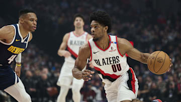 Mar 21, 2025; Portland, Oregon, USA; Portland Trail Blazers guard Scoot Henderson (00) drives to the basket during the first half against Denver Nuggets guard Russell Westbrook (4) at Moda Center. Mandatory Credit: Troy Wayrynen-Imagn Images
