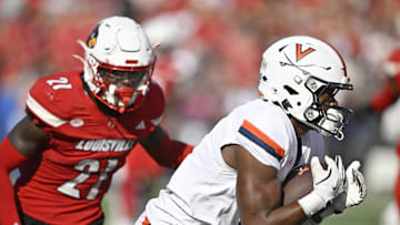 Oct 4, 2025; Louisville, Kentucky, USA; Virginia Cavaliers wide receiver Cam Ross (6) catches a pass against Louisville Cardinals defensive back D'Angelo Hutchinson (21) during the second quarter at L&N Federal Credit Union Stadium. Mandatory Credit: Jamie Rhodes-Imagn Images