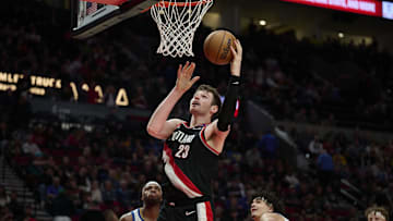 Apr 11, 2025; Portland, Oregon, USA; Portland Trail Blazers center Donovan Clingan (23) scores a basket during the second half against the Golden State Warriors at Moda Center. Mandatory Credit: Troy Wayrynen-Imagn Images