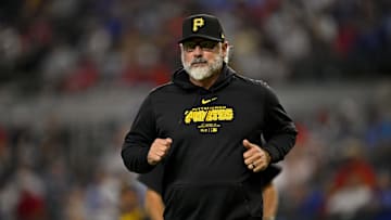 Aug 21, 2024; Arlington, Texas, USA; Pittsburgh Pirates manager Derek Shelton (17) runs back to the doughnut during the game against the Texas Rangers at Globe Life Field. Mandatory Credit: Jerome Miron-Imagn Images