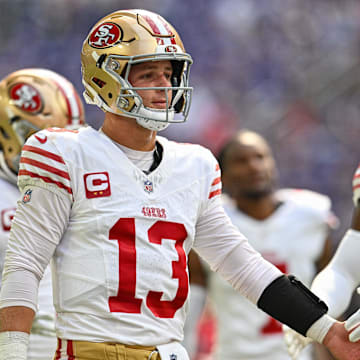 Sep 15, 2024; Minneapolis, Minnesota, USA; San Francisco 49ers quarterback Brock Purdy (13) warms up with teammates before the game against the Minnesota Vikings at U.S. Bank Stadium. Mandatory Credit: Jeffrey Becker-Imagn Images