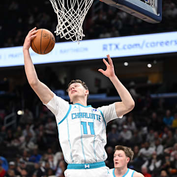 Oct 26, 2025; Washington, District of Columbia, USA; Charlotte Hornets center Ryan Kalkbrenner (11) grabs a rebound against the Washington Wizards during the first quarter at Capital One Arena. Mandatory Credit: Rafael Suanes-Imagn Images
