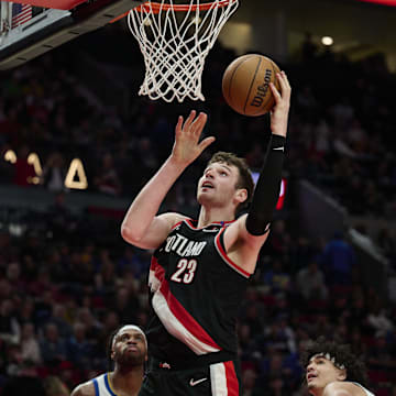 Apr 11, 2025; Portland, Oregon, USA; Portland Trail Blazers center Donovan Clingan (23) scores a basket during the second half against the Golden State Warriors at Moda Center. Mandatory Credit: Troy Wayrynen-Imagn Images