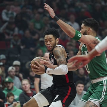 Mar 23, 2025; Portland, Oregon, USA;  Portland Trail Blazers guard Anfernee Simons (1) dribbles the ball during the first half against Boston Celtics forward Jayson Tatum (0) at Moda Center. Mandatory Credit: Troy Wayrynen-Imagn Images