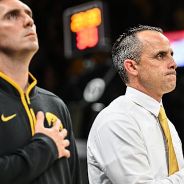 Nov 4, 2025; Iowa City, Iowa, USA; Iowa Hawkeyes head coach Ben McCollum stands for the national anthem at Carver-Hawkeye Arena for his first game as the Hawkeyes head coach before the game against the Robert Morris Colonials. Mandatory Credit: Jeffrey Becker-Imagn Images