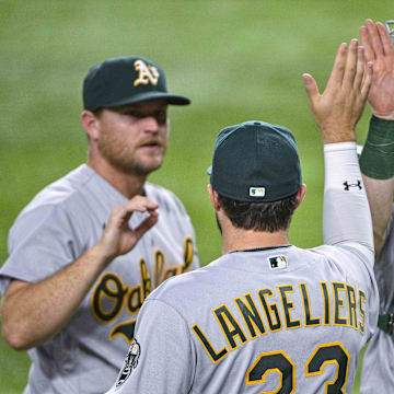 Aug 17, 2022; Arlington, Texas, USA; Oakland Athletics designated hitter Shea Langeliers (23) and catcher Sean Murphy (12) celebrate after the victory over the Texas Rangers at Globe Life Field. Mandatory Credit: Jerome Miron-Imagn Images